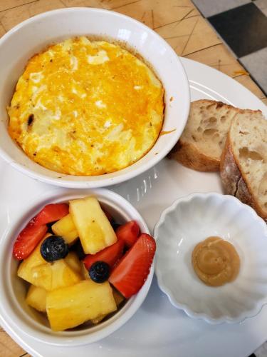 a white plate with two bowls of food and bread at Bayberry Inn B&B and Oregon Wellness Retreat in Ashland