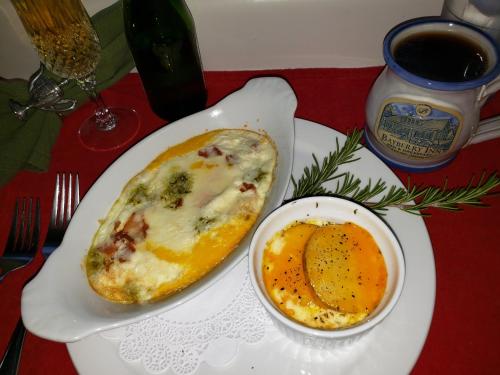 a white plate with an egg and a bowl of food at Bayberry Inn B&B and Oregon Wellness Retreat in Ashland
