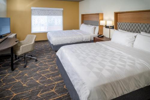 a hotel room with two beds and a desk and a computer at Holiday Inn Hotel & Suites Beckley by IHG in Beckley