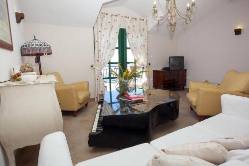 a living room with a glass table and yellow chairs at Holiday house with a parking space Gornji Tucepi - Tomasi, Makarska - 6818 in Tučepi