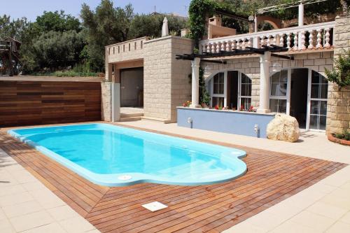a swimming pool in front of a house at Apartments with swimming pool Tucepi, Makarska - 6817 in Tučepi