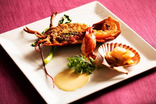 a white plate of food with lobster and other foods at Garden Terrace Fukuoka in Fukuoka