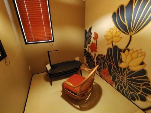 a room with a chair and a bench in a room at 龍馬坂荘：1日1組限定・東山清水のてっぺんの小さなお宿、わんこと一緒に。 in Kyoto