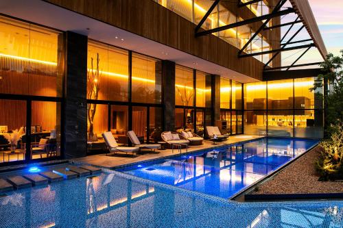 an indoor swimming pool in a building with a resort at Garden Terrace Fukuoka in Fukuoka