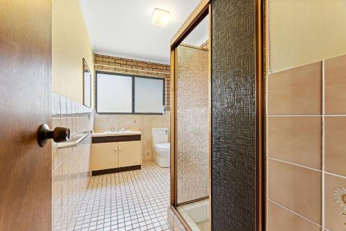 a bathroom with a toilet and a sink at Grandview Apartment Ocean Views in Kianga