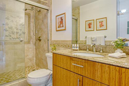 a bathroom with a toilet and a sink and a shower at Menehune Shores 626 in Kihei