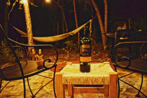 a bottle of beer sitting on a chair on a table at Pequeña cabaña mágica con chimenea interior in Arteaga