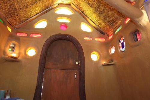a room with a wooden door and a ceiling with lights at Gingerbread House in Geyserville