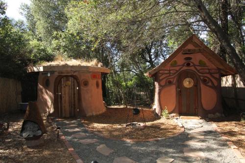 a dog house and a play house in a yard at Gingerbread House in Geyserville