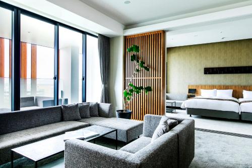 a living room with a couch and a bed at Garden Terrace Fukuoka in Fukuoka