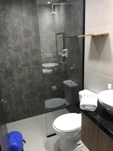 a bathroom with a shower and a toilet and a sink at Stanza Equipetrol in Santa Cruz de la Sierra