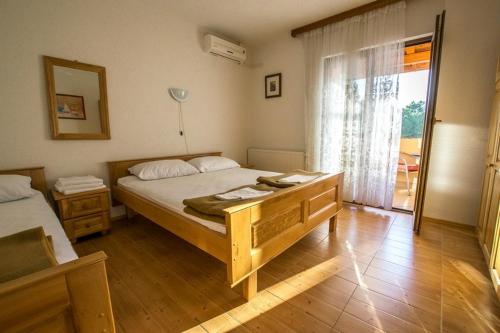a bedroom with a large bed and a window at Apartments with a parking space Starigrad, Paklenica - 6595 in Starigrad-Paklenica