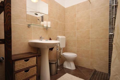 a bathroom with a sink and a toilet at Apartments by the sea Funtana, Porec - 6905 in Funtana
