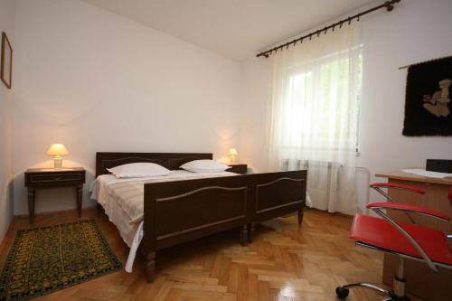 a bedroom with a large bed and a window at Apartments with a parking space Biograd na Moru, Biograd - 6446 in Biograd na Moru