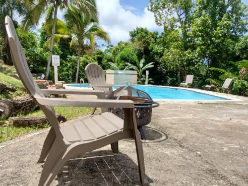 a chair and a grill next to a swimming pool at Casa Grande Vacation Home and Events Venue in Rio Grande