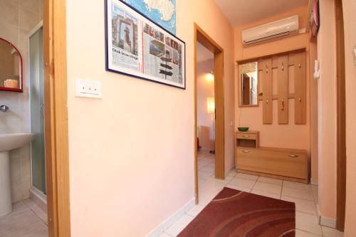 a hallway with a bathroom with a sink and a mirror at Apartments by the sea Zaklopatica, Lastovo - 8325 in Lastovo
