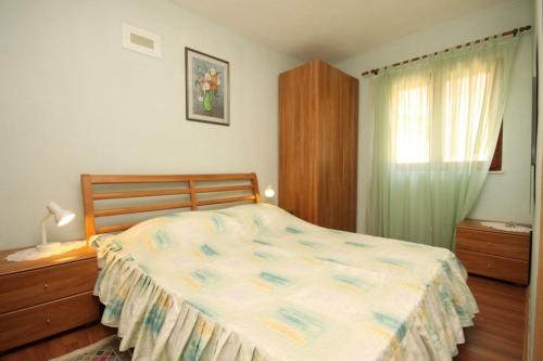 a bedroom with a bed and a dresser and a window at Apartments by the sea Skrivena Luka, Lastovo - 8352 in Lastovo