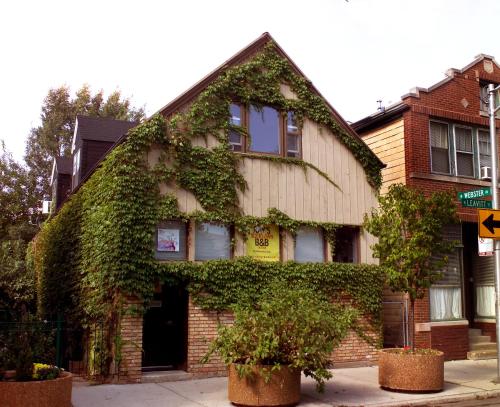 an ivy covered building on the corner of a street at Ray's Bucktown Bed and Breakfast in Chicago