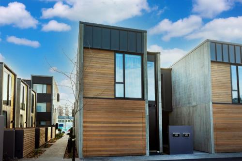 a modern house with wooden doors and windows at URBAN RETREAT luxury city stay in Christchurch