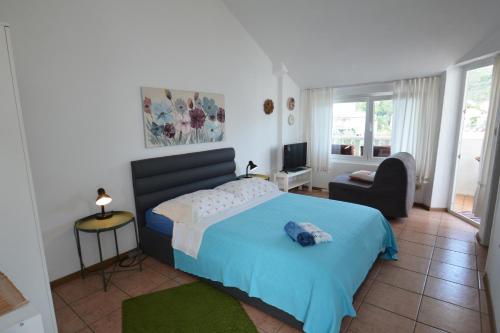 um quarto com uma cama azul e uma cadeira em Apartments and rooms by the sea Zaglav, Dugi otok - 8170 em Sali