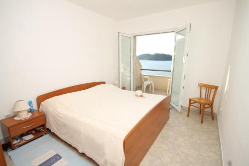Schlafzimmer mit einem Bett und Meerblick in der Unterkunft Apartments by the sea Ubli, Lastovo - 8355 in Ubli