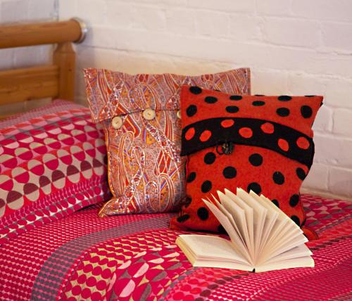 an open book sitting on top of a bed with pillows at B&B at The Old Mill in Devizes