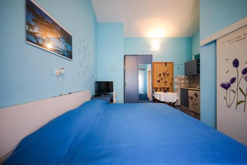 a blue bedroom with a large blue bed at Studio Brbinj 8160a in Brbinj