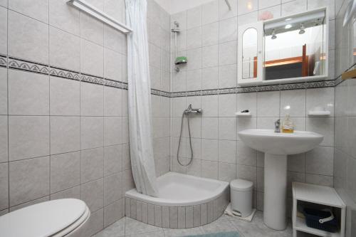 a white bathroom with a sink and a toilet at Studio Zaklopatica 8393a in Lastovo