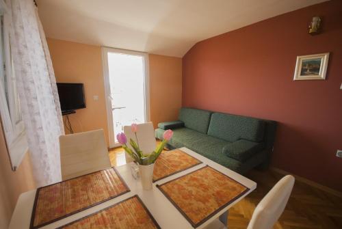 a living room with a table and a couch at Apartments by the sea Kukljica, Ugljan - 8253 in Kukljica