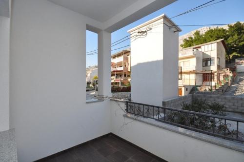 a balcony with a view of a street at Apartments by the sea Duce, Omis - 8633 in Omiš