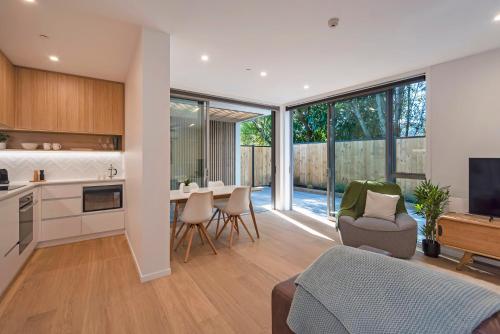 a living room with a kitchen and a dining room at Malthouse Lane City Apartment 2 in Nelson