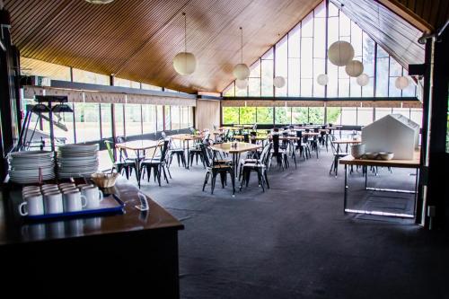 a restaurant with tables and chairs and a large window at Fiordland Hotel in Te Anau