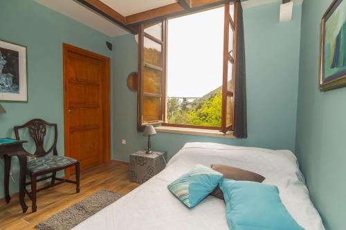 a bedroom with a bed and a window at Seaside house with a swimming pool Mokosica, Dubrovnik - 8583 in Mokošica