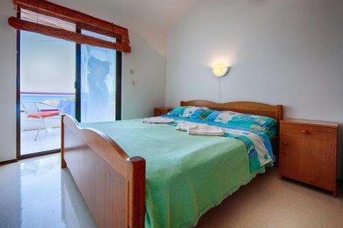 a bedroom with a bed with a view of the ocean at Apartments and rooms by the sea Zaklopatica, Lastovo - 8339 in Lastovo