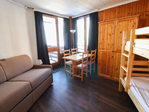 a living room with a couch and a table and chairs at Studio Tignes, 1 pièce, 4 personnes - FR-1-502-417 in Tignes