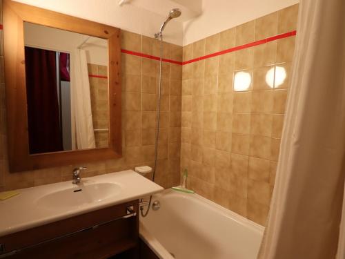 une salle de bain avec un lavabo, une baignoire et un miroir dans l'établissement Appartement au pied des pistes à Tignes - Balcon, Parking, Ski, et Activités Incluses - FR-1-502-409, à Tignes