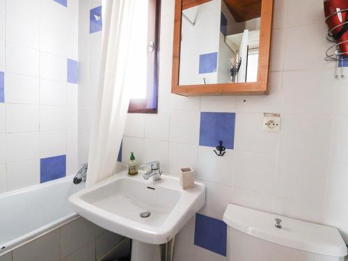 a bathroom with a sink and a toilet and a mirror at Studio Tignes, 1 pièce, 2 personnes - FR-1-502-439 in Tignes