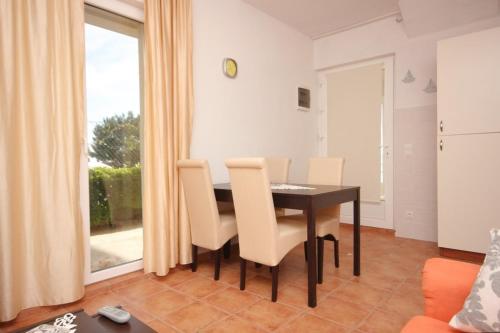 a dining room with a table and chairs at Apartments by the sea Zavala, Hvar - 8637 in Jelsa