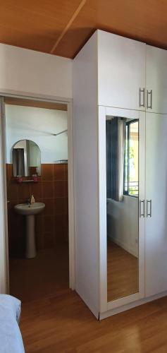 a room with a bathroom with a sink and a mirror at Lola's Guest House in Mactan