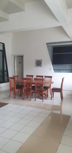 a dining room with wooden chairs and a table at Lola's Guest House in Mactan