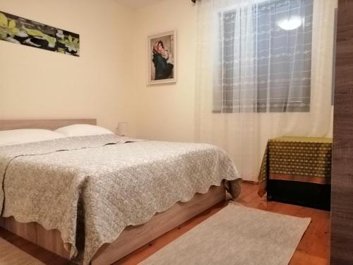 a bedroom with a bed and a window at Apartment Lukoran 8397b in Lukoran