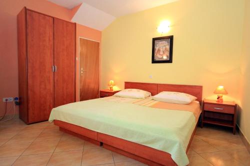 a bedroom with a large bed and two night stands at Apartments with WiFi Dubrovnik - 8590 in Dubrovnik
