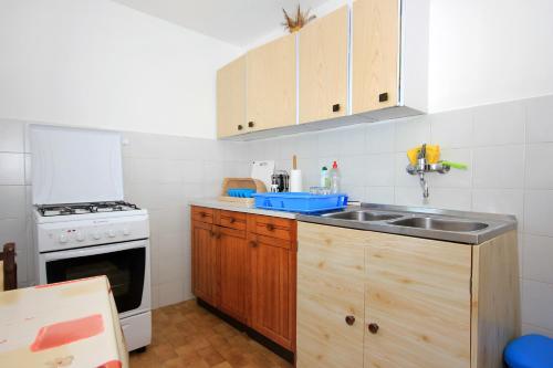 a kitchen with a sink and a stove at Apartments with WiFi Dubrovnik - 8590 in Dubrovnik