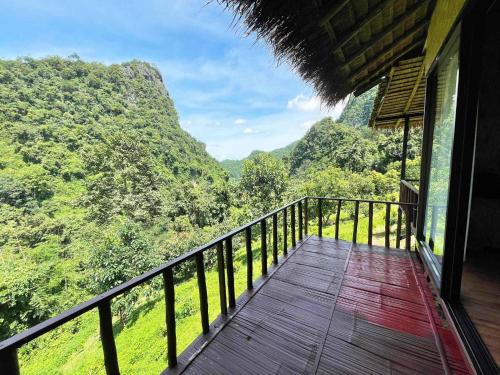 a balcony of a house with a view of the mountains at ม่านฟ้า โฮมสเตย์ MaanFah Homestay in Chiang Rai