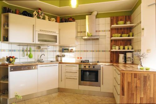 a kitchen with white appliances and green walls at Apartments by the sea Ugljan - 8468 in Ugljan