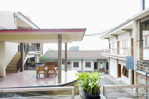 a balcony of a house with a table and chairs at Urbanview Hotel Bergas Indah Bandungan by RedDoorz in Bandungan