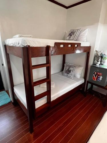 a couple of bunk beds in a room at Balay Paragua in El Nido