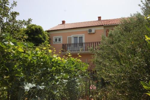 a house with a balcony in the middle of trees at Apartment Kraj 8288a in Kraj