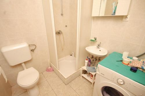 a small bathroom with a toilet and a sink at Apartments by the sea Lukoran (Ugljan) - 8510 in Lukoran