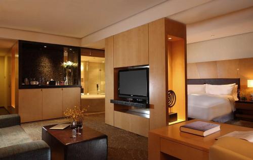 a hotel room with a bed and a television at Crowne Plaza Tianjin Binhai by IHG in Tianjin